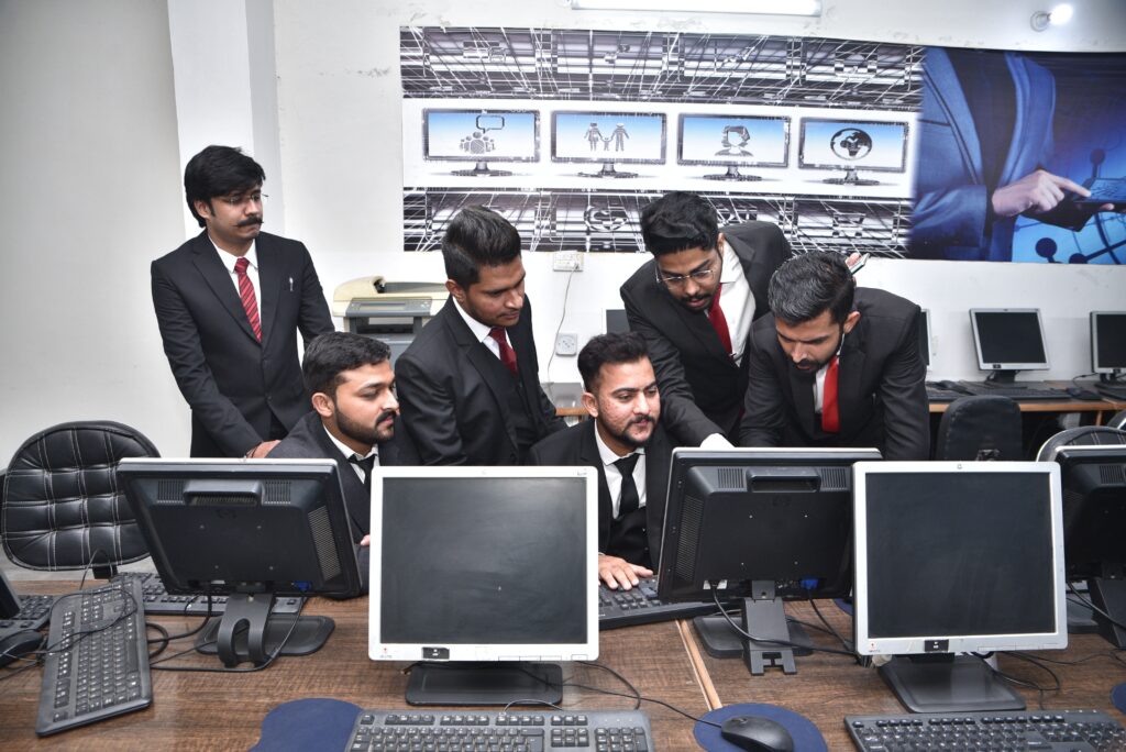 Group of professionals collaborating on computer work in a modern office.
